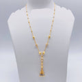 Gold necklace with tassel pendant on a mannequin bust, weight 7.770g, brand 'Sj221'.
