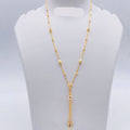 Gold necklace on a gray mannequin bust with weight indication