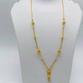 Gold necklace on a mannequin bust with weight and length information.