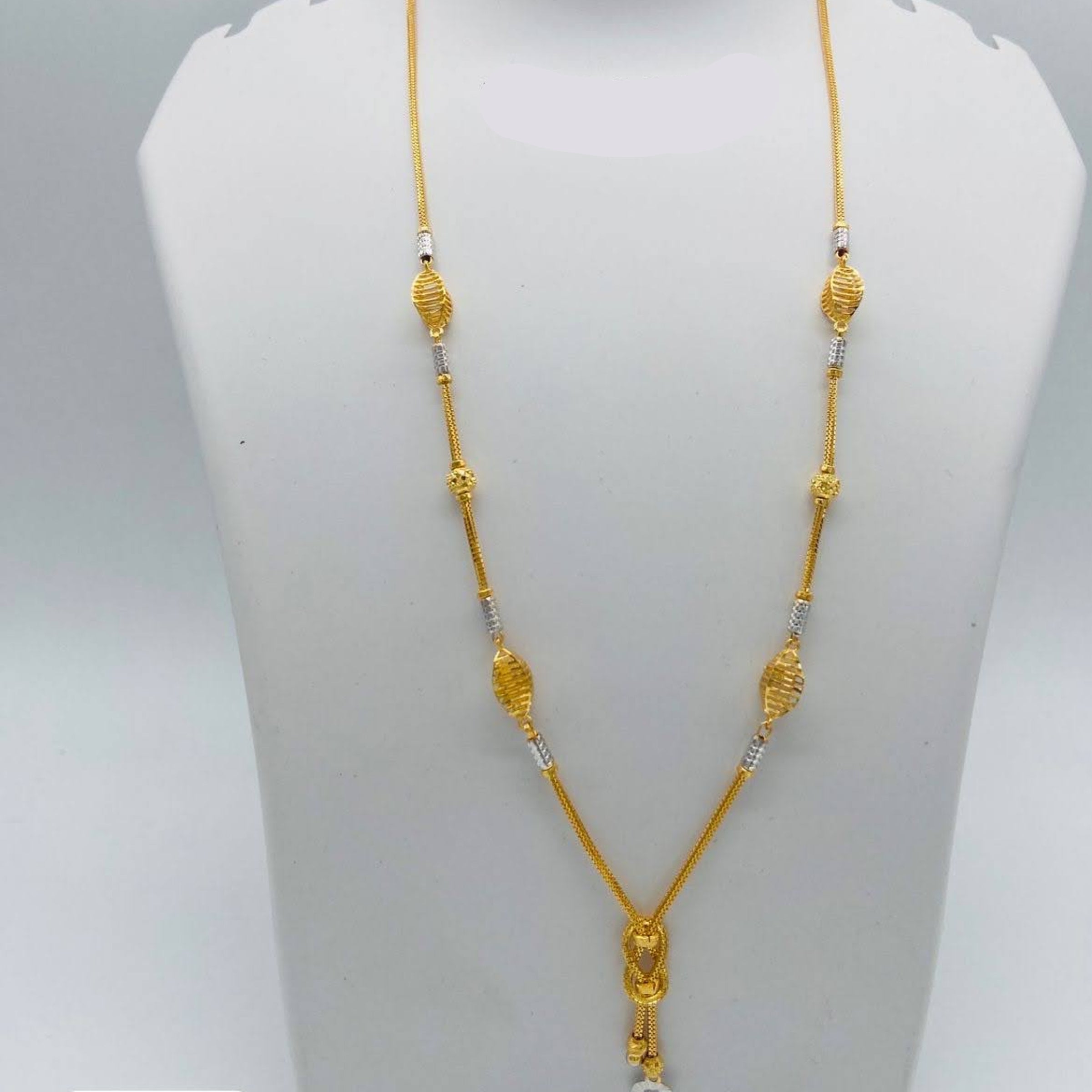 Gold necklace on a mannequin bust with weight and length information.