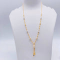 Gold necklace on a white mannequin bust with weight indication