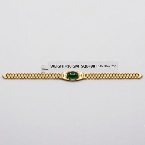 A gold bracelet with a central green oval stone and decorative side details, displayed on a light gray background with a small label showing weight and dimensions.