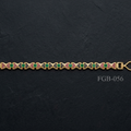A gold-plated bracelet featuring a repeating pattern of green round-cut stones and pink enamel details, displayed horizontally on a dark textured slate background.