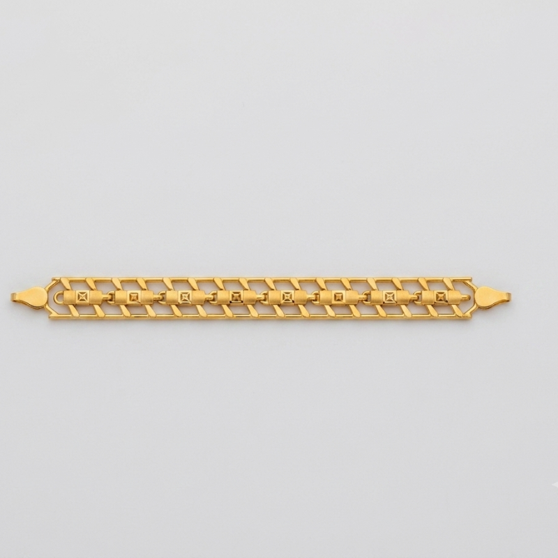 A gold chain bracelet with the name 'GABRIELLE' spelled out in the center of the links, displayed horizontally on a light gray background.