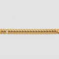 A gold-toned metal link bracelet with a repeating geometric pattern, displayed horizontally against a light gray background.