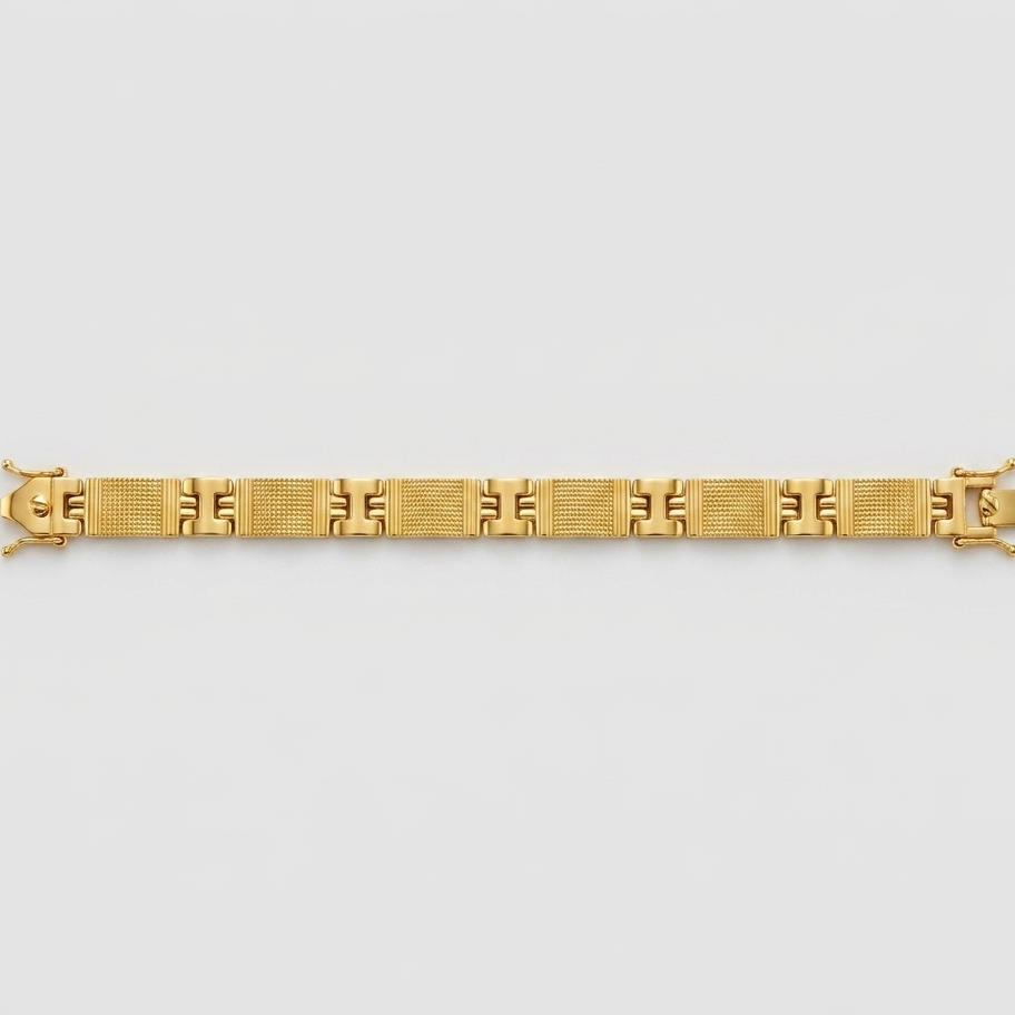 A gold link bracelet with a geometric pattern, displayed horizontally against a light gray background.