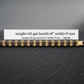 A gold-tone link bracelet with rectangular dark inlays, displayed on a dark textured surface with a white label overlay showing specifications: weight=26 gm, leanth=8", width=9 mm.