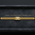 A gold Rolex Jubilee bracelet displayed horizontally inside a black velvet jewelry box, with gold text above reading 'WEIGHT= 15 GM LEANTH-8" WIDTH= 11 MM SQB-119 92K T DOL-22'.