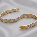 A two-tone metal bracelet with alternating gold, silver, and rose gold textured and smooth rectangular links, displayed on a soft gray satin fabric background.