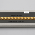 A gold Cuban link chain bracelet displayed on a gray textured block with overlaid dimensions and weight information: weight=18.00gm, width=12mm, length=8".