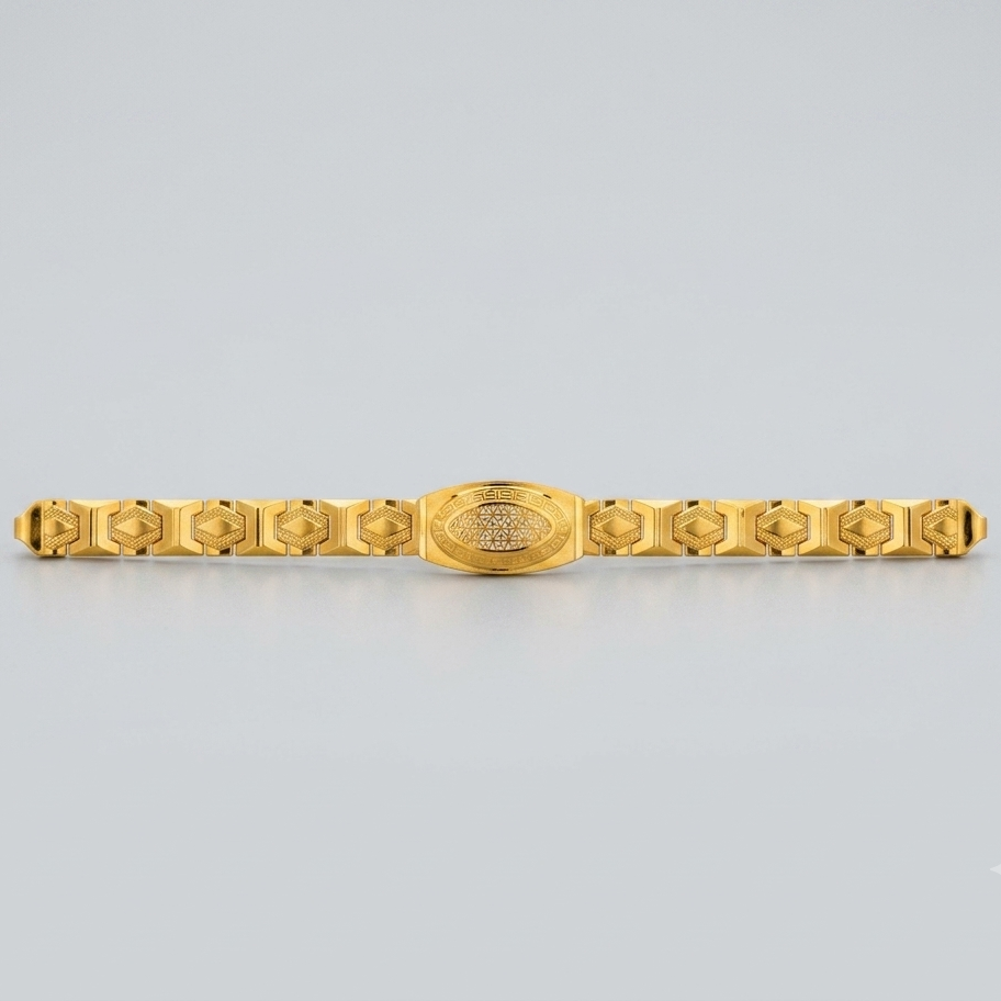 A gold-plated metal bracelet with a central oval medallion and repeating geometric links on either side, shown against a light gray background.