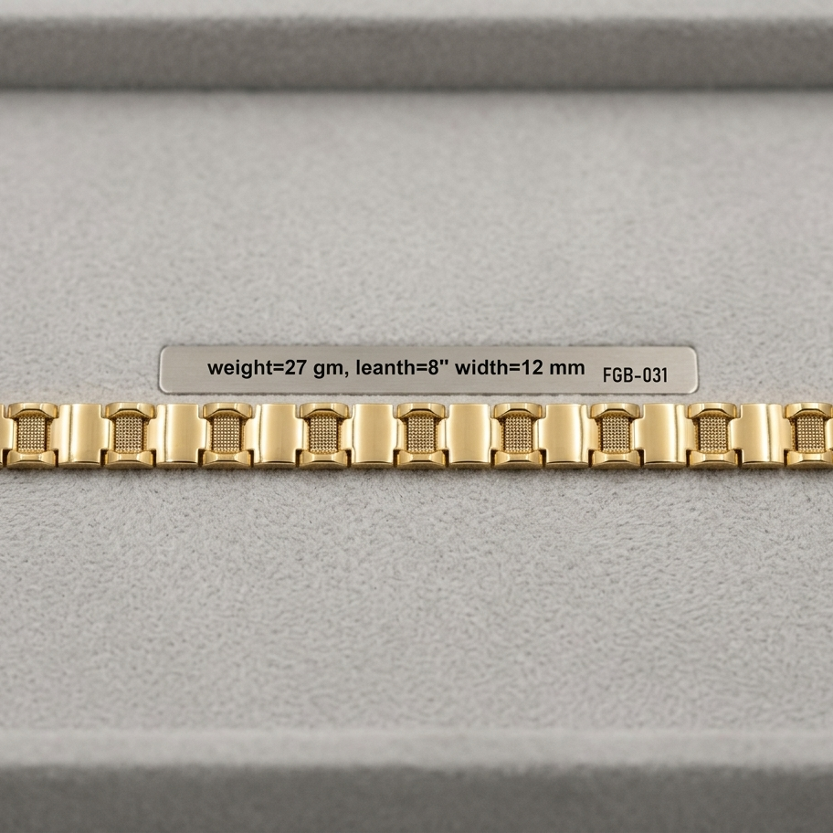 A gold-colored metal watch band with a repeating rectangular link pattern, displayed horizontally on a gray textured surface with a small label above it.