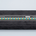A yellow gold bracelet with turquoise blue bezel-set round stones, displayed horizontally on a black velvet jewelry box. The image includes a text overlay with specifications: 'WEIGHT=11 GM LEANTH=8" WIDTH=7 MM FCB-085 12KT'.