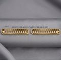 Two gold-plated diamond bands shown on a gray fabric background, with text detailing the specifications: 'DOL=27 WEIGHT=12 GM LEANTH=8" WIDTH=7 MM SQB=60 92KT'.