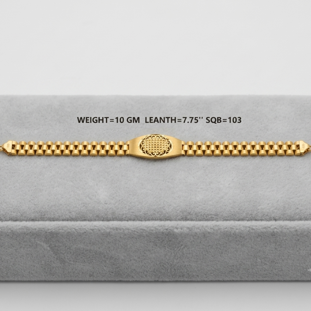 A gold bracelet displayed on a gray velvet jewelry box. The bracelet features a central textured oval clasp and a beaded link design.
