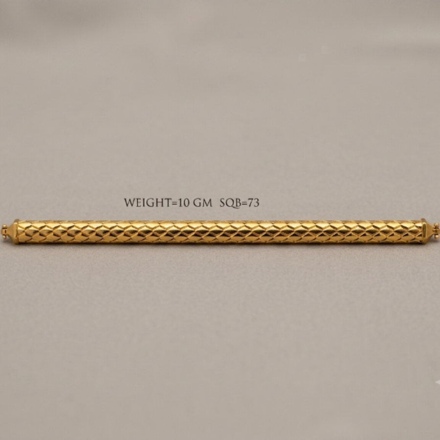 A gold cylindrical bar with a textured diamond-patterned surface, displayed horizontally on a neutral gray background with a text overlay indicating its weight and dimensions.