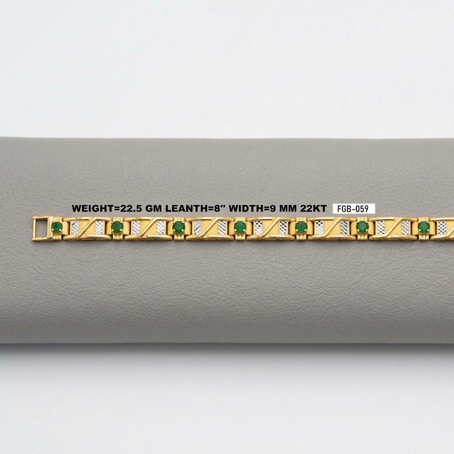 A gold bracelet with green emerald-cut stones and gold geometric detailing, displayed horizontally on a gray textured surface with a white label showing specifications.