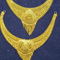 A pair of traditional Indian gold-toned jewelry pieces, likely a necklace and matching collar or choker, displayed on a dark blue velvet surface.
