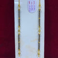 Two gold and black beaded necklaces on a white card with a red background