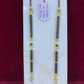 Two beaded necklaces with gold accents on a white card with a red background