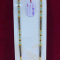 Two beaded necklaces on a white stand with a red background