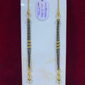 Two gold and black beaded necklaces on a white card with a red background