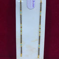 Two beaded necklaces on a white card with a visible tag, against a red background.