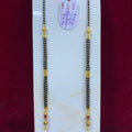 Two gold necklaces on a white card with a red background
