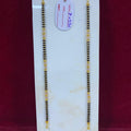 Two gold necklaces on a white card with a red background