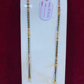 Two beaded necklaces on a white card with a red background