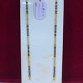 Two gold necklaces on a white card with a red background