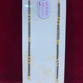 Two gold necklaces on a white card with a red background
