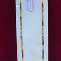 Gold necklace on a white card with a red background