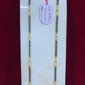 Two gold necklaces on a white card with a red background