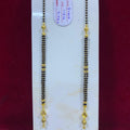 Two gold and black beaded necklaces on a white card with a red background