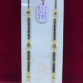 Two gold and black beaded necklaces on a white card with a red background