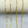 Gold chain necklace on a gray surface with weight and length information.