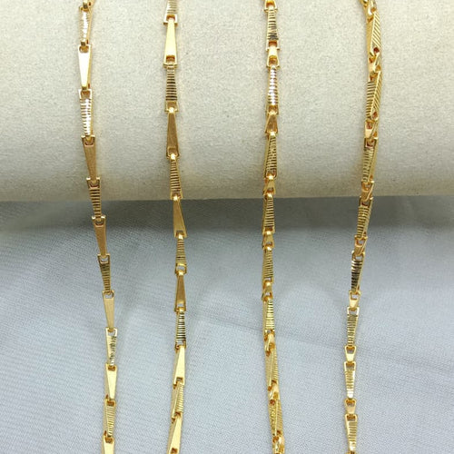 Gold chain necklace on a gray surface with weight and length information.