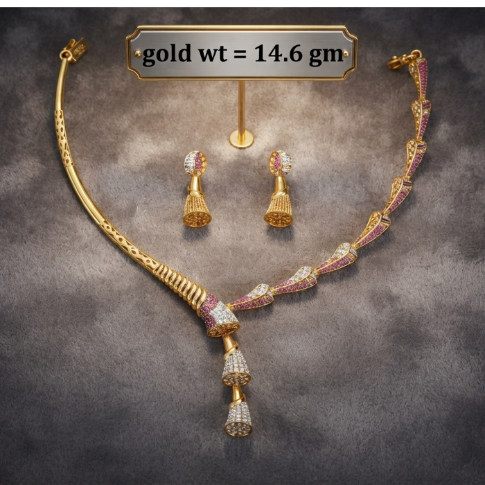 Gold-toned jewelry set displayed on a dark textured background, including a necklace, matching earrings, and a small stand. A label at the top reads 'gold wt = 14.