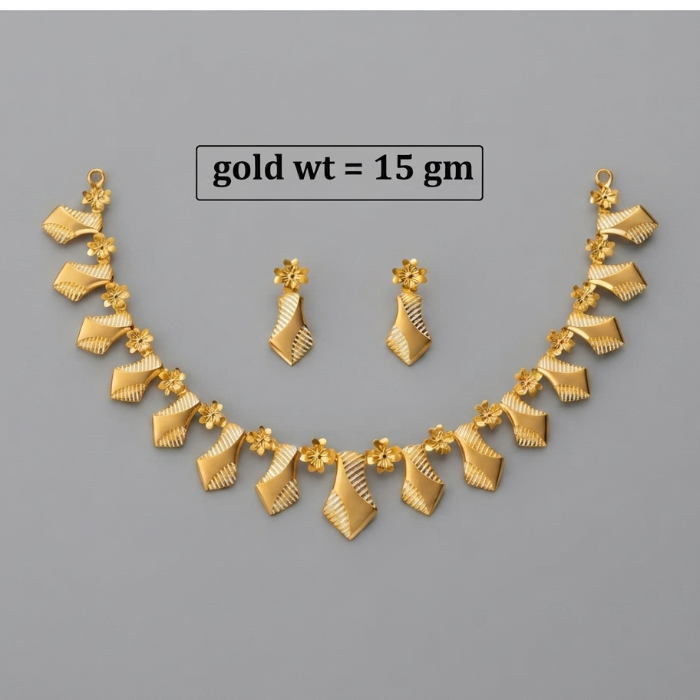 Gold jewelry set featuring a necklace and matching earrings with textured, wave-like leaf or ribbon motifs and small floral accents, displayed on a plain gray background with text reading 'gold wt = 15 gm'.