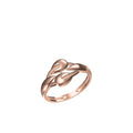 A rose gold ring with a sculptural, intertwined knot-like design, shown on a plain white background with a product code label and 'IDC' logo at the bottom.