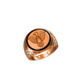 A rose gold signet ring featuring an embossed eagle design on a circular face, accented with a black band and small clear stones on the shoulders, shown against a plain white background.