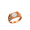 A rose gold signet ring with a flat top featuring a circular silver-toned emblem, shown on a plain white background with a model number and brand logo in the lower left.