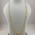 A gold chain necklace displayed on a white mannequin bust, with a digital scale visible underneath.