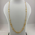 A gold multi-strand beaded necklace displayed on a white mannequin bust, with a digital scale visible underneath.