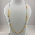 A gold chain necklace displayed on a white mannequin bust, with a digital scale visible underneath. The scale screen shows a weight reading of 8.