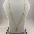 A gold necklace displayed on a white mannequin bust, with a digital scale visible underneath. The necklace features a delicate chain with textured bead clusters and a small key-shaped pendant.