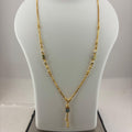 A gold necklace with small green bead accents and a dangling rectangular pendant, displayed on a white jewelry bust atop a digital scale showing 93.7 grams.