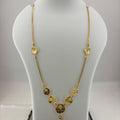 A gold chain necklace with faceted round beads and a central pendant, displayed on a white mannequin bust over a digital scale showing 8.75 grams.