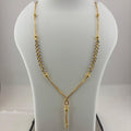 A gold-tone necklace displayed on a white mannequin bust, with a digital scale visible underneath to show the weight. The necklace features a Y-shaped design with one side in textured chain links and the other in a smoother chain, ending in a small dangling pendant.